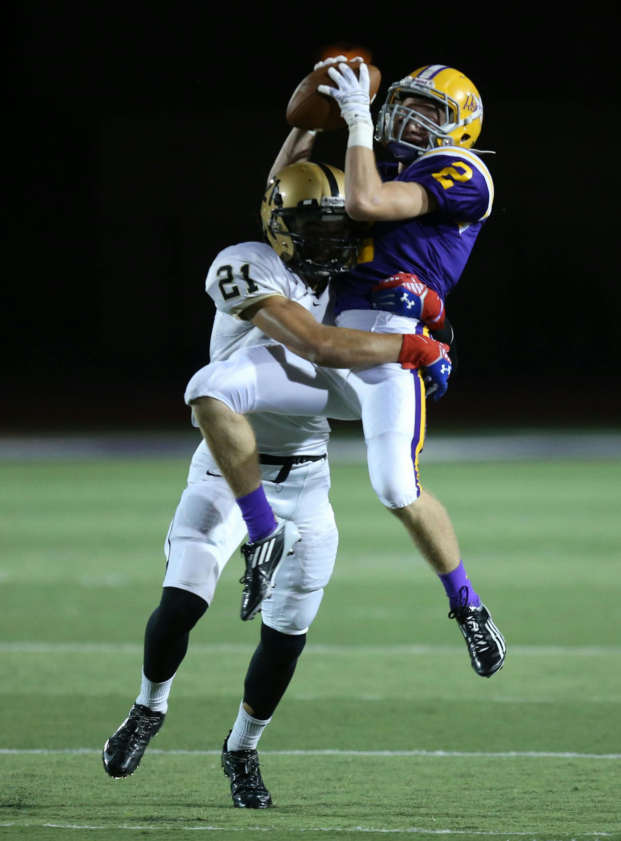 Cretin-Derham Hall's Jonathan Gores made the catch with East Ridge's Kyle Orehosky in the first half. ] (KYNDELL HARKNESS/STAR TRIBUNE) kyndell.harkness@startribune.com Cretin-Derham Hall vs East Ridge in St. Paul Min., Friday, August, 5, 2014.