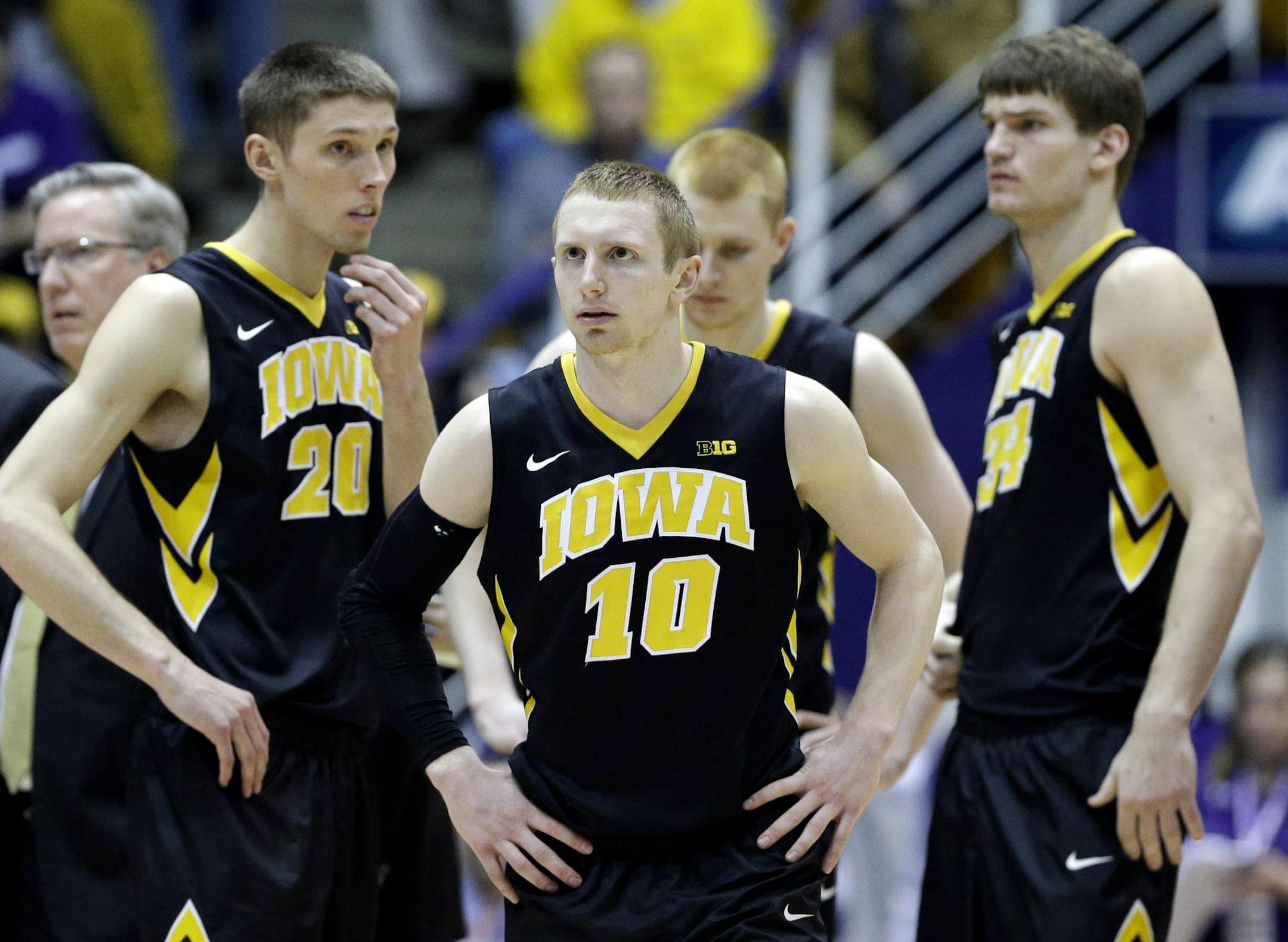 Iowa guard Mike Gesell (10), forward Jarrod Uthoff (20), forward Aaron White (30), and center Adam Woodbury (34) react during the second half of an NCAA college basketball game against Northwestern on Sunday, Feb. 15, 2015, in Evanston, Ill. Northwestern won in overtime 66-61. (AP Photo/Nam Y. Huh)