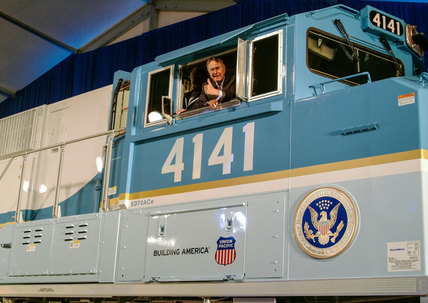 George H.W. Bush looks out of the cab of Union Pacific locomotive 4141 at its 2005 unveiling in College Station, Texas.