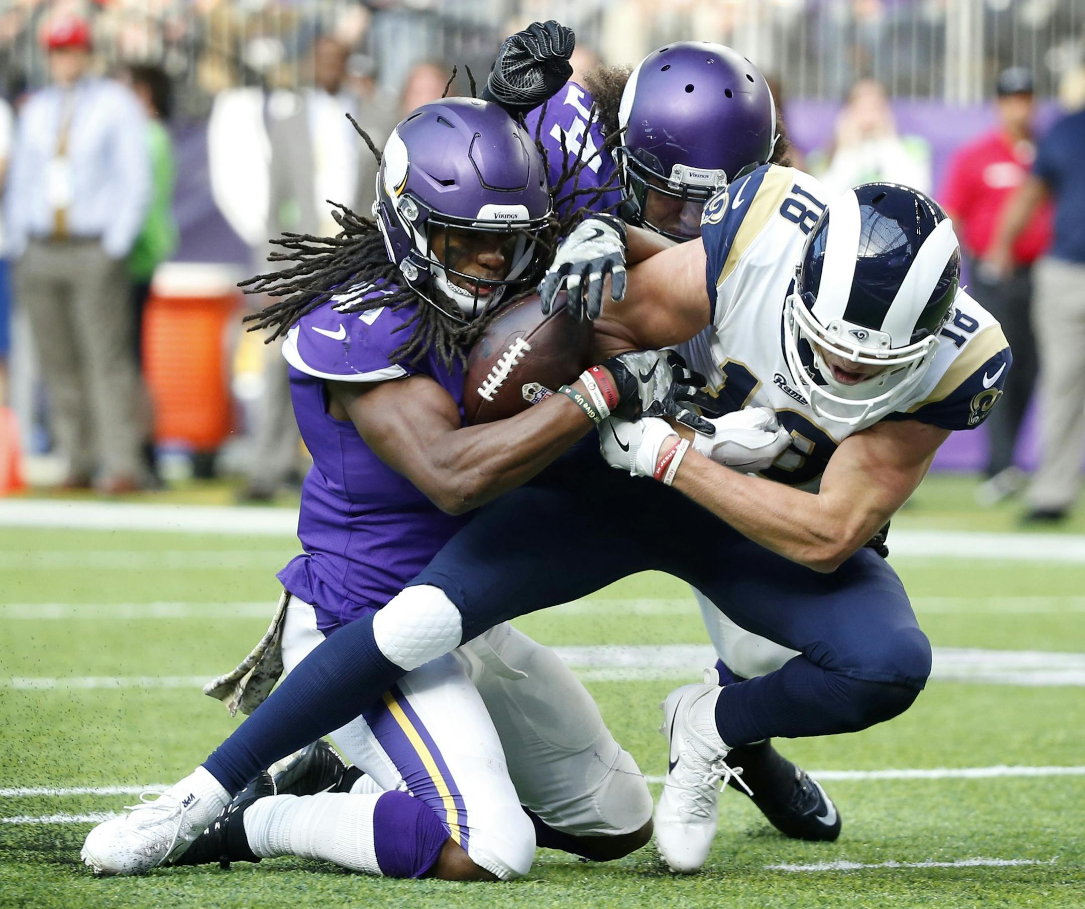 Vikings strong safety Anthony Harris, left, stripped the ball from Rams wide receiver Cooper Kupp near the goal line during the first half Sunday. Harris also recovered the fumble.