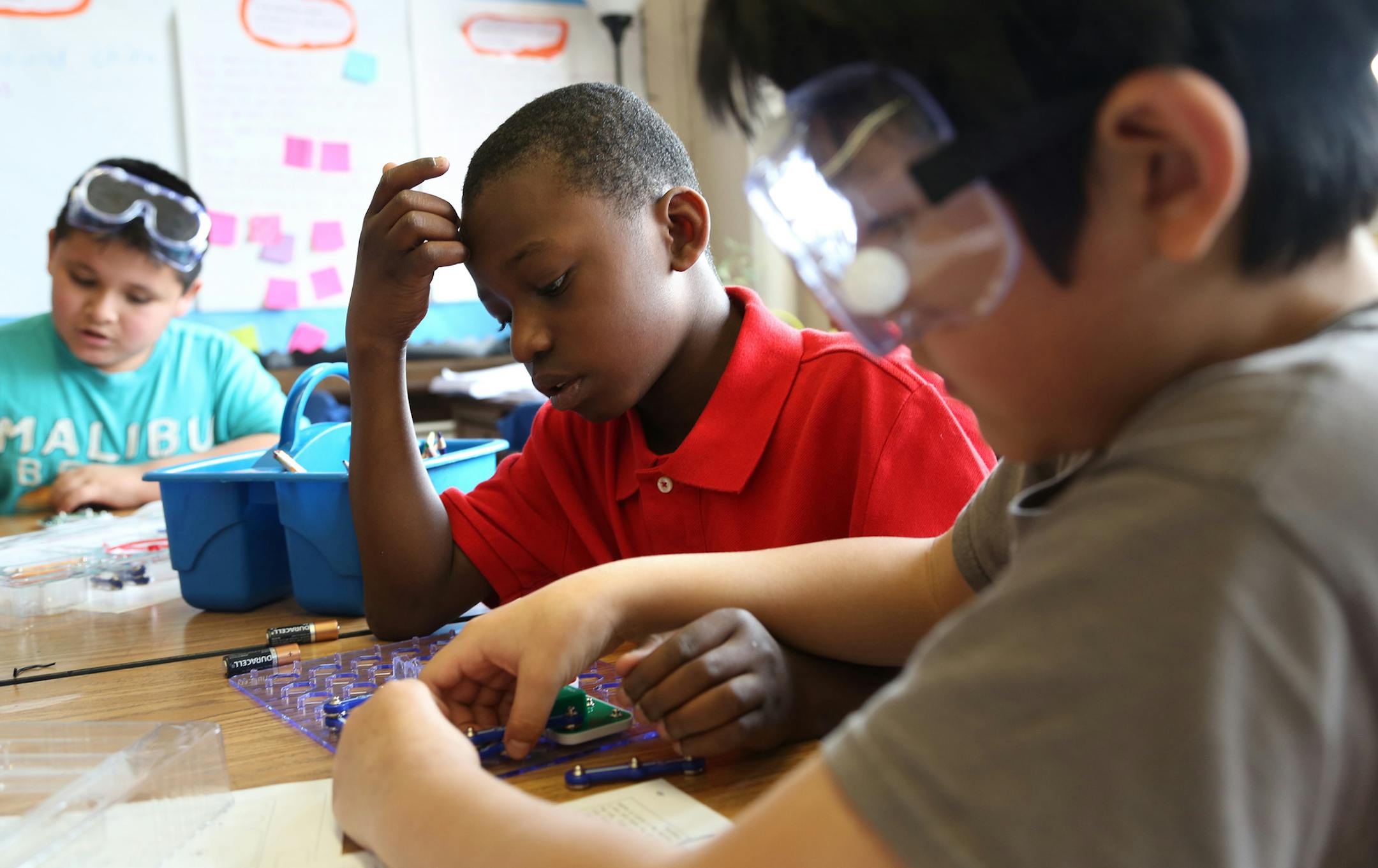 Third grader Dujuan Walker watched as his partner Danny Sibri, worked on adding pieces to their circuit board as a part of a science project. ] (KYNDELL HARKNESS/STAR TRIBUNE) kyndell.harkness@startribune.com Students take part in school during spring break at Bancroft Elementary in Minneapolis Min., Wednesday, April 1, 2014.