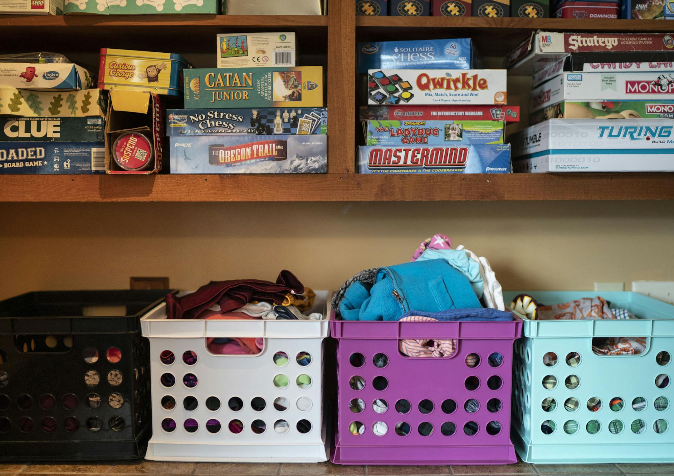 The laundry room has a bin for each child's clean, folded clothes.