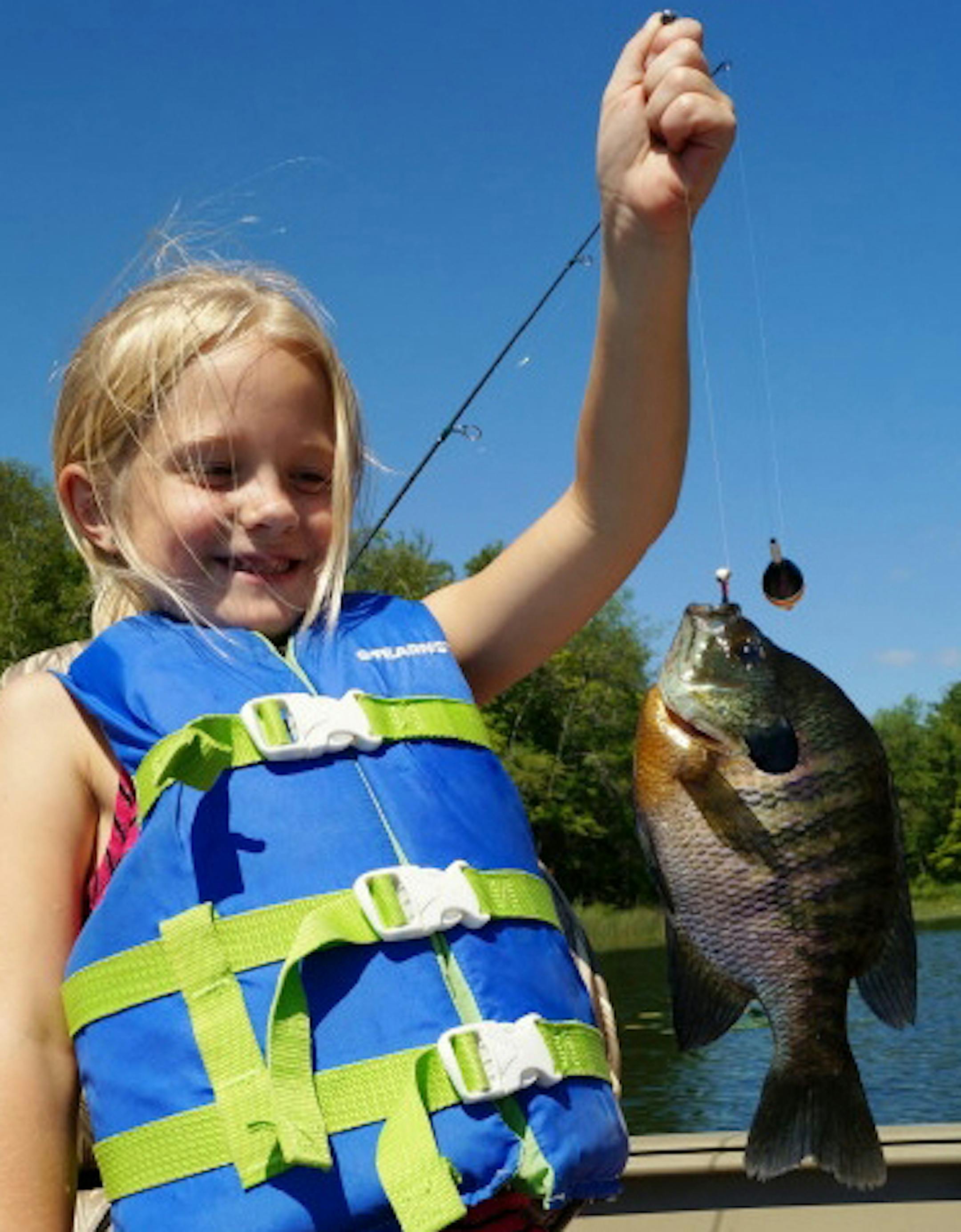 PANFISH BONANZA Isabella Maliske, 7, of Mandan, N.D., went fishing for her first time with her grandpa and grandma and a fishing guide to a Bemidji-area lake -- and hit paydirt with panfish. Isabella caught 32 fish in four hours. Her best was this trophy 10-inch bluegill.