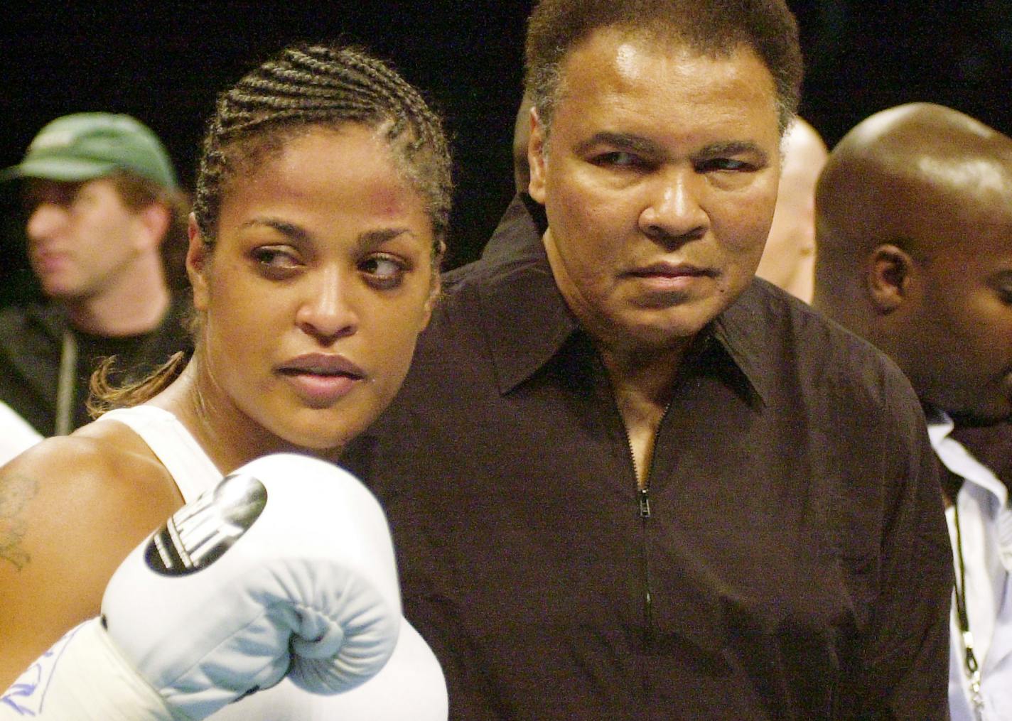 Laila Ali with her father, boxing great Muhammad Ali, after winning the IBA Super Middleweight title in 2002.