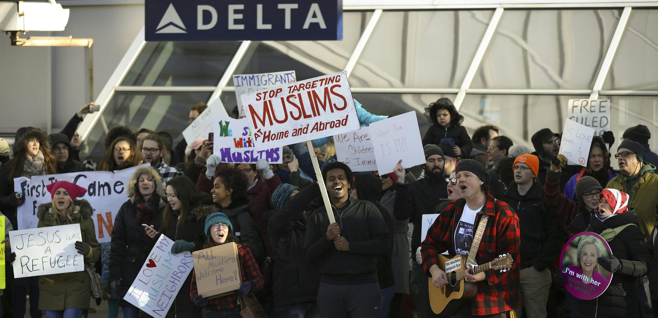 Demonstrators gathered across the street from Terminal 1 sang "This Land is Your Land" Sunday afternoon. ] JEFF WHEELER ï jeff.wheeler@startribune.com Several hundred demonstrators took part in a second day of protests at the MSP airport's Terminal 1 against President Trump's new immigration policies Sunday afternoon, January 29, 2017. The group carried signs and chanted slogans for about two and a half hours before being told by airport police that they faced arrest if they didn't disperse
