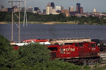 Locomotives traveled on tracks next to Highway 61 near the Canadian Pacific rail yard by Pig's Eye Lake.