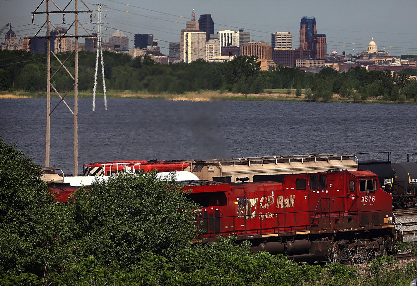 Locomotives traveled on tracks next to Highway 61 near the Canadian Pacific rail yard by Pig's Eye Lake.