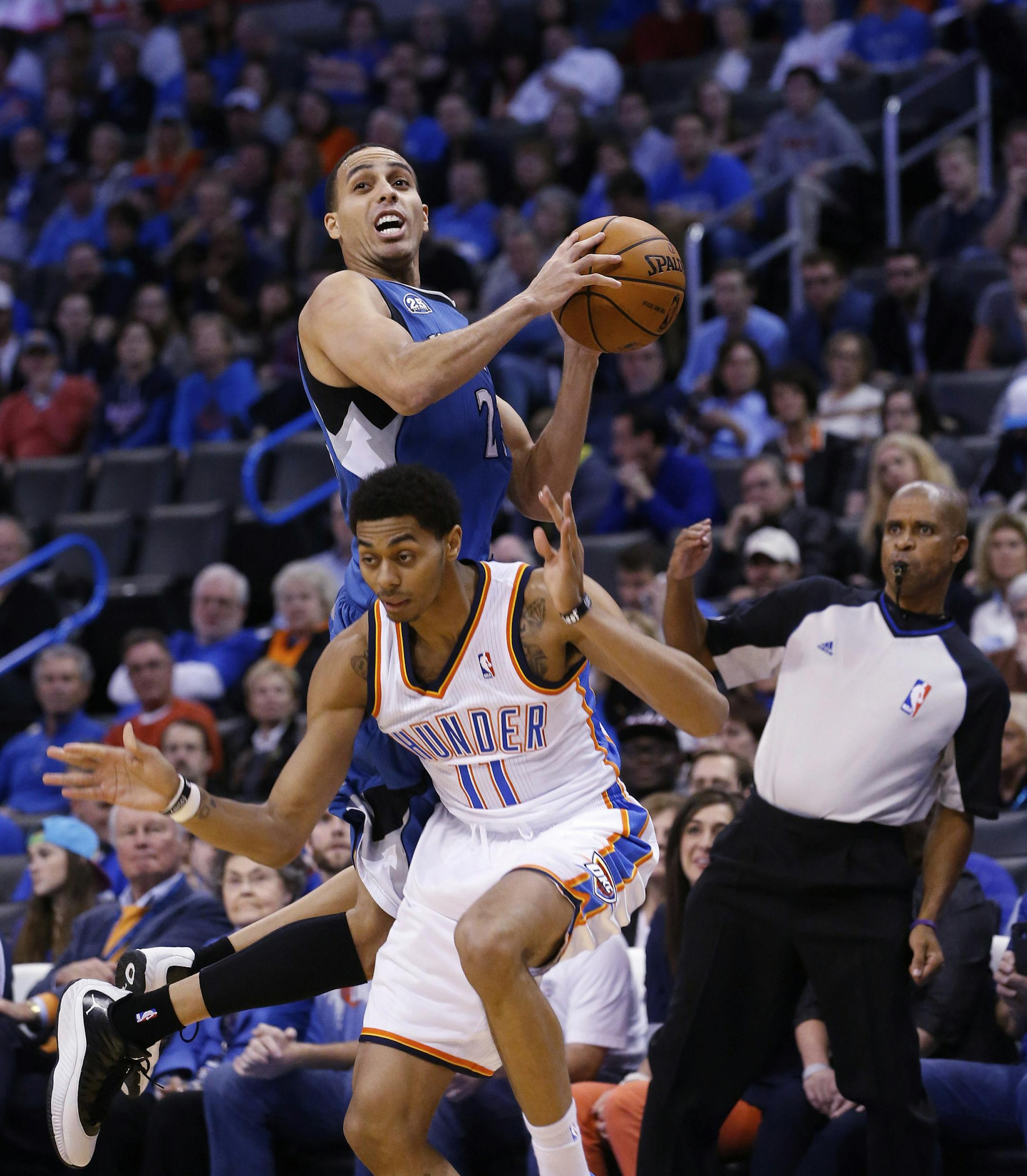 Minnesota Timberwolves guard Kevin Martin (23) is fouled by Oklahoma City Thunder guard Jeremy Lamb (11) in the first quarter of an NBA basketball game in Oklahoma City, Sunday, Dec. 1, 2013. (AP Photo/Sue Ogrocki)