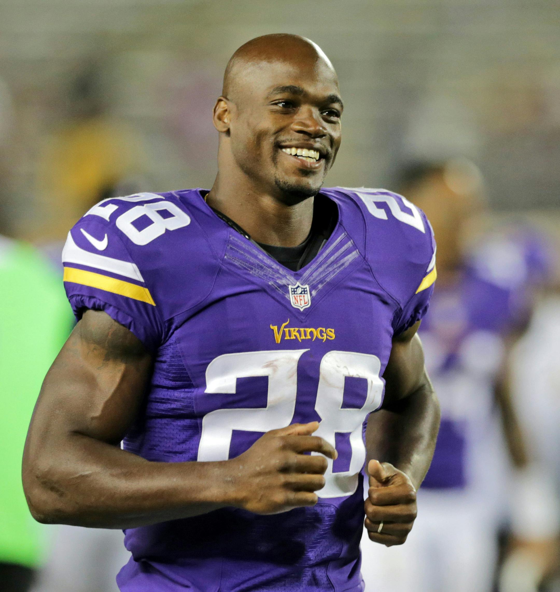 FILE - In this Aug. 8, 2014, file photo, Minnesota Vikings running back Adrian Peterson leaves the field after an NFL preseason football game against the Oakland Raiders in Minneapolis. The Minnesota Vikings will open their optional team practices this week without Peterson. The star running back has told coach Mike Zimmer that he will not attend the three days of team work that begin Tuesday, a person with knowledge of the situation told The Associated Press on Sunday, May 24, 2015. The person