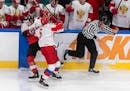 Russia’s Semyon Chistyakov (6) checked Austria’s Marco Rossi (23) during a World Junior Championship game on Dec. 29.