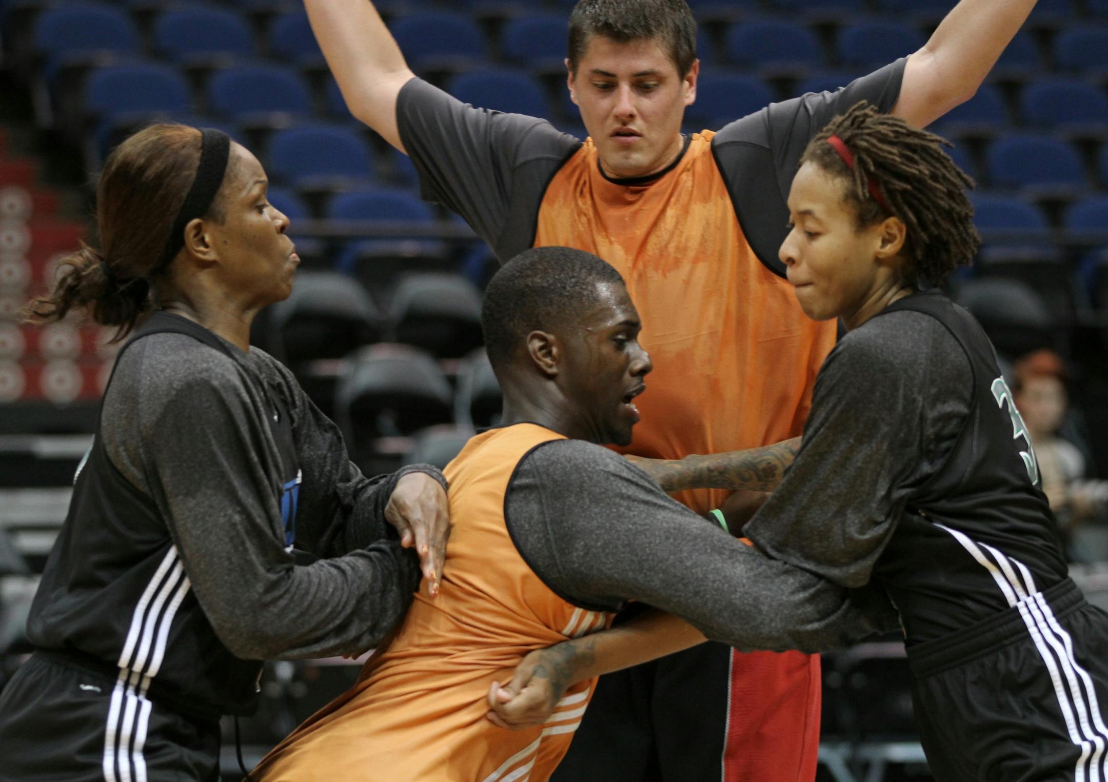 Taj McWilliams-Franklin (left) and Seimone Augustus battled against male workout players Kene Anigbogu (front) and Dan Andersen during a practice. The Lynx practice against a rotating group of 20 men, allowing them to use their entire roster like they could in a game.