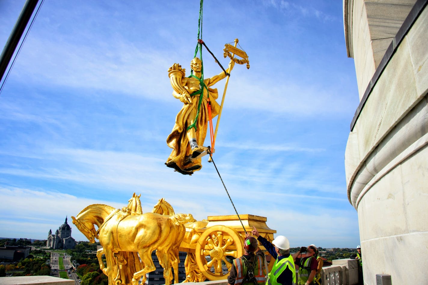 The charioteer figure who guides the golden horses on the Minnesota State Capitol Building's Quadriga statue were temporarily removed on Tuesday, September 23 to repair corrosion discovered at the statue's base. The repair is expected to take approximately three months when charioteer will return to the Quadriga.