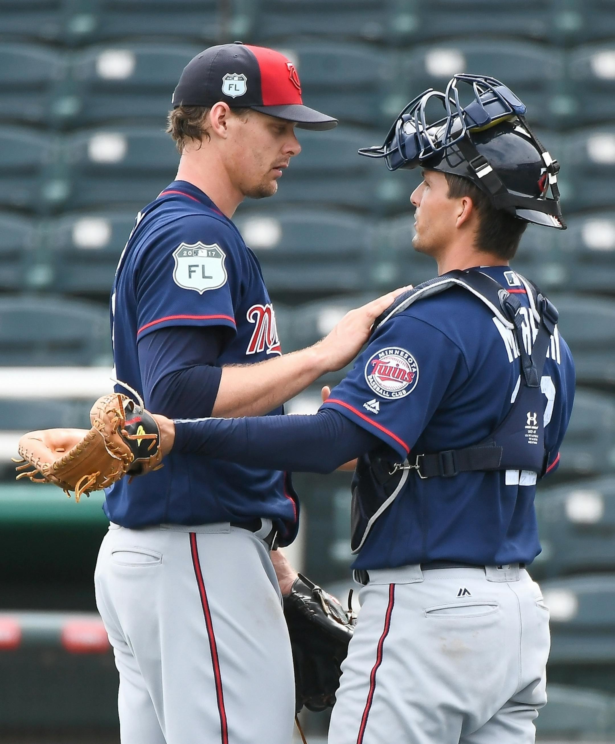 Minnesota Twins catcher John Ryan Murphy (12) greeted pitcher Justin Haley (58) after Haley finished throwing for live batting practice Tuesday.