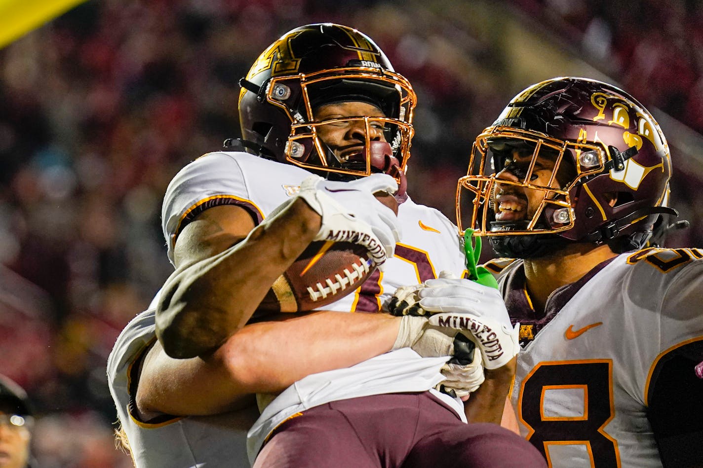 Teammates celebrate with Minnesota wide receiver Le'Meke Brockington (0) after his game-winning touchdown late in the second half of an NCAA college football game Saturday, Nov. 26, 2022, in Madison, Wis. Minnesota won 23-16. (AP Photo/Andy Manis)