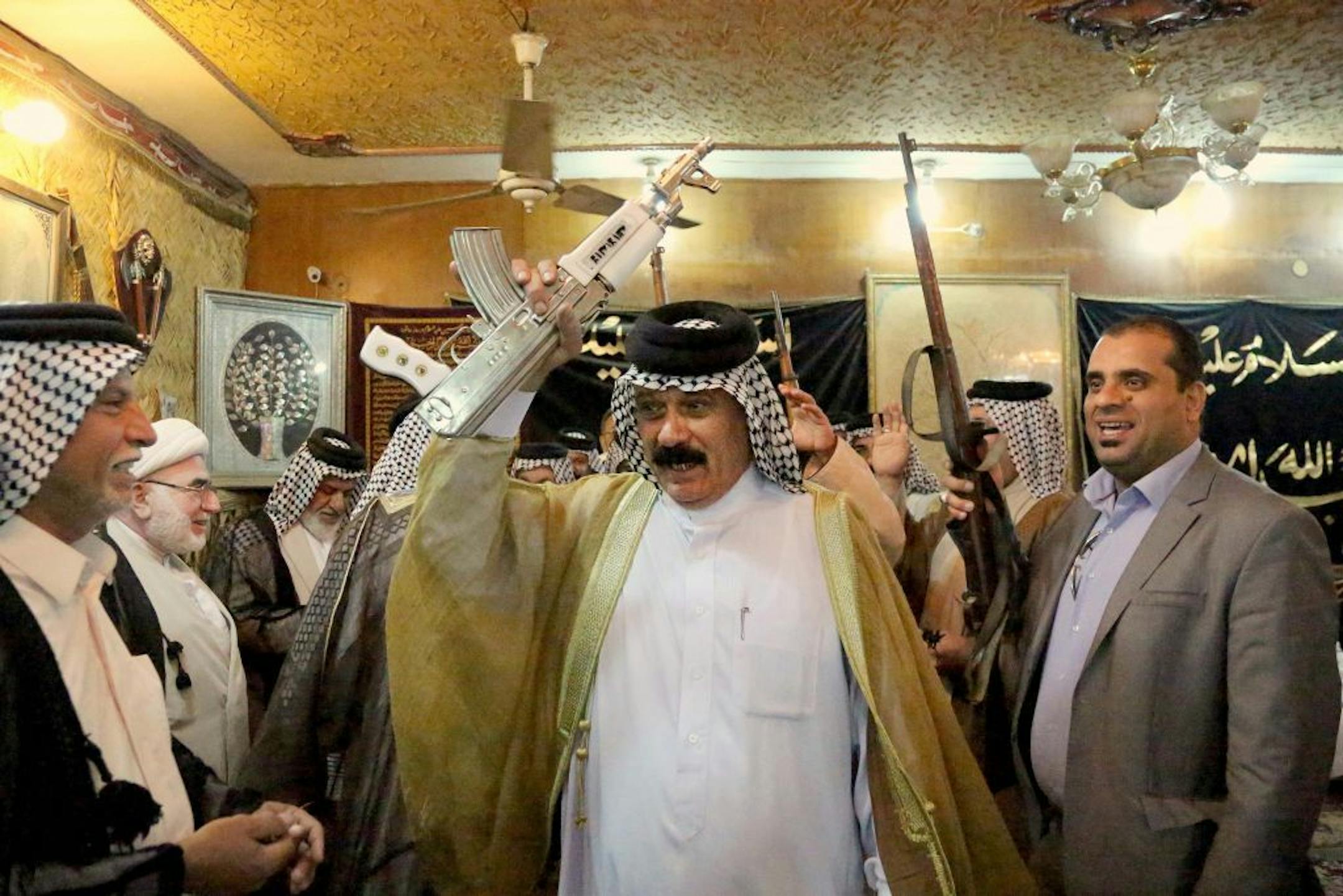 Iraqi Shiite tribal leaders chant slogans against the al-Qaida-inspired Islamic State of Iraq and the Levant (ISIL), in Baghdad, Iraq, Friday, June. 13, 2014.
