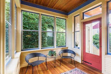 The tongue-and-groove flooring and beadboard ceiling of the side porch is fir wood.