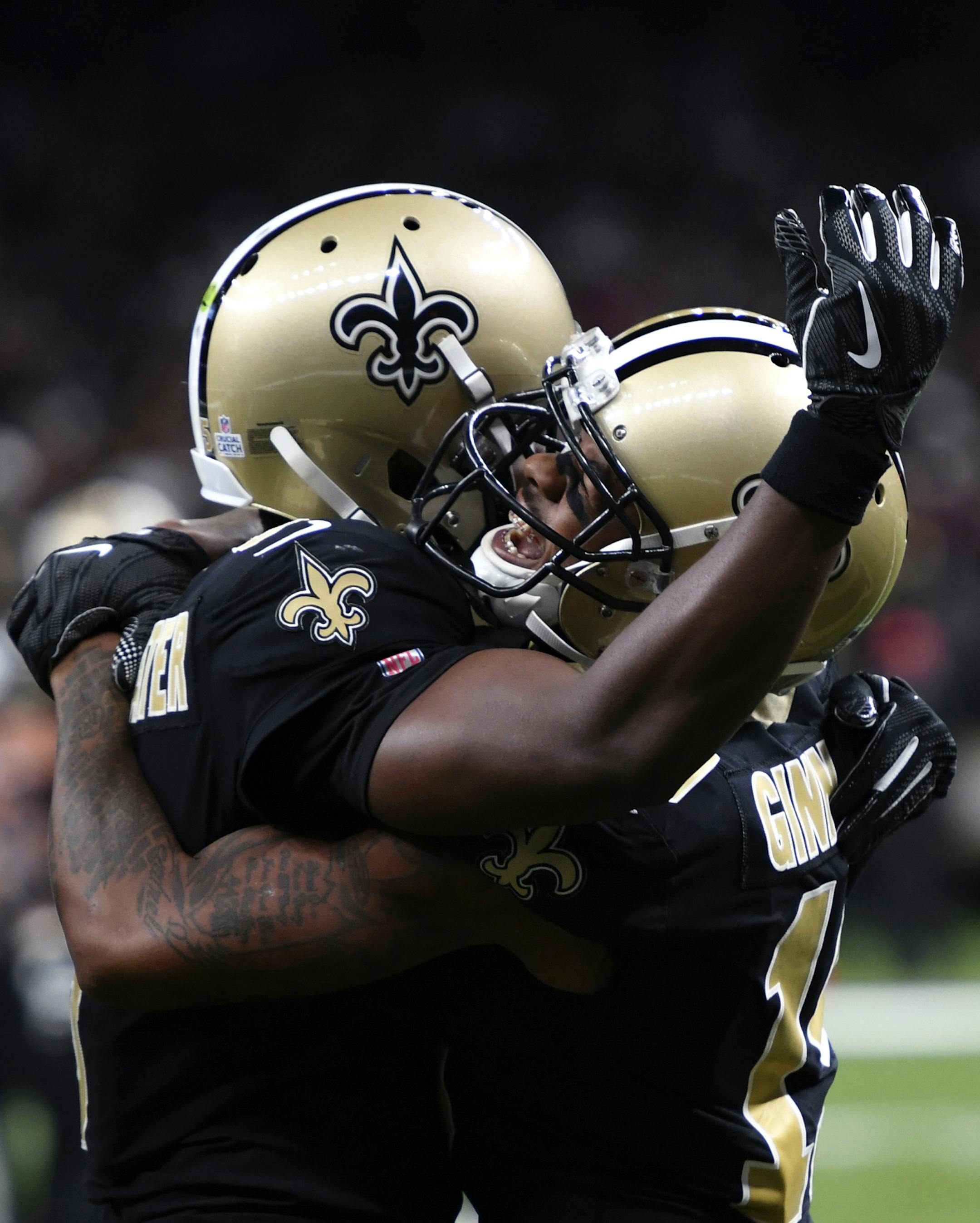 New Orleans Saints wide receiver Ted Ginn, right, celebrates his touchdown reception with quarterback Teddy Bridgewater in the second half of an NFL football game against the Tampa Bay Buccaneers in New Orleans, Sunday, Oct. 6, 2019. (AP Photo/Bill Feig)