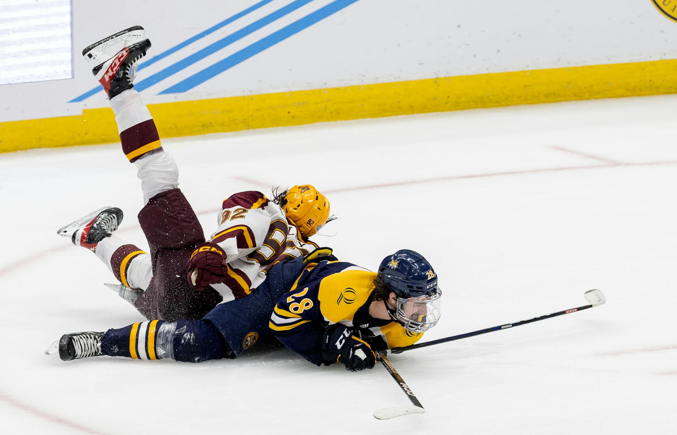 Logan Cooley (92) of Minnesota tangles up with Sam Lipkin (28) in the third period. Cooley called for a penalty on the play.