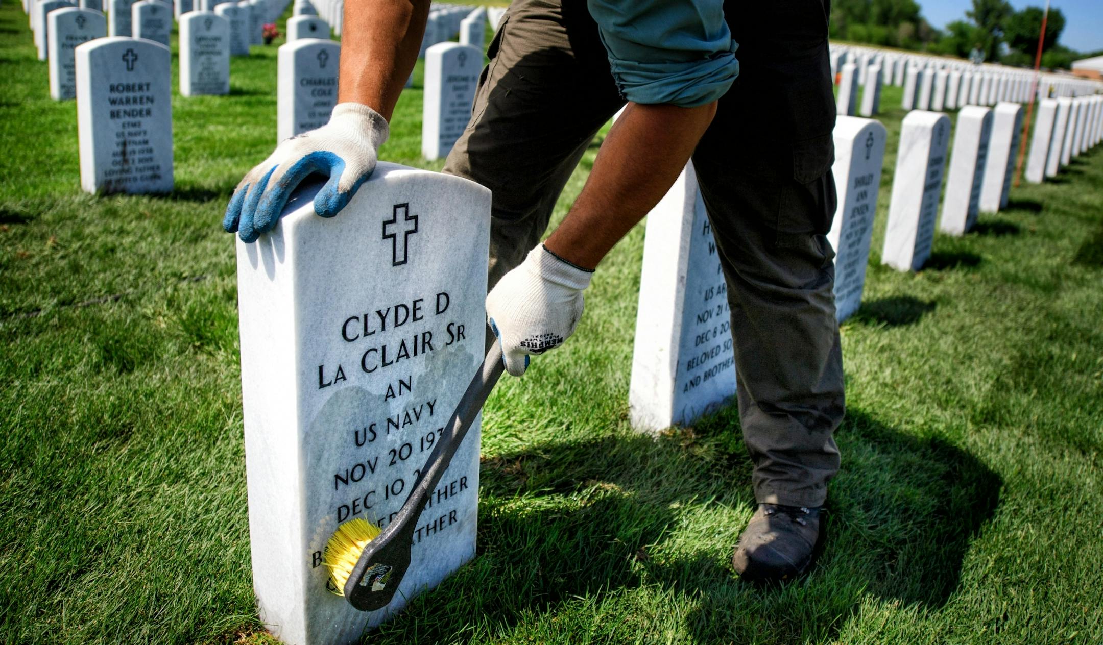 Joe Jandrich carefully hand scrubbed grave markers in a new section of Fort Snelling National Cemetery where fresh sod had just been installed.