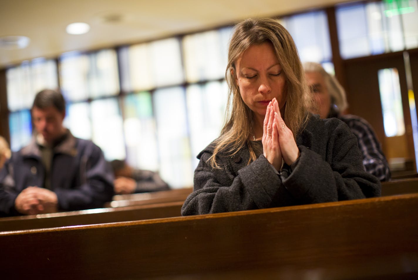 Jennifer Hildebrand of St. Paul prayed during noon mass at Saint Olaf Catholic Church on Friday, January 16, 2015, in Minneapolis, Minn. ] RENEE JONES SCHNEIDER &#x2022; renee.jones@yahoo.com