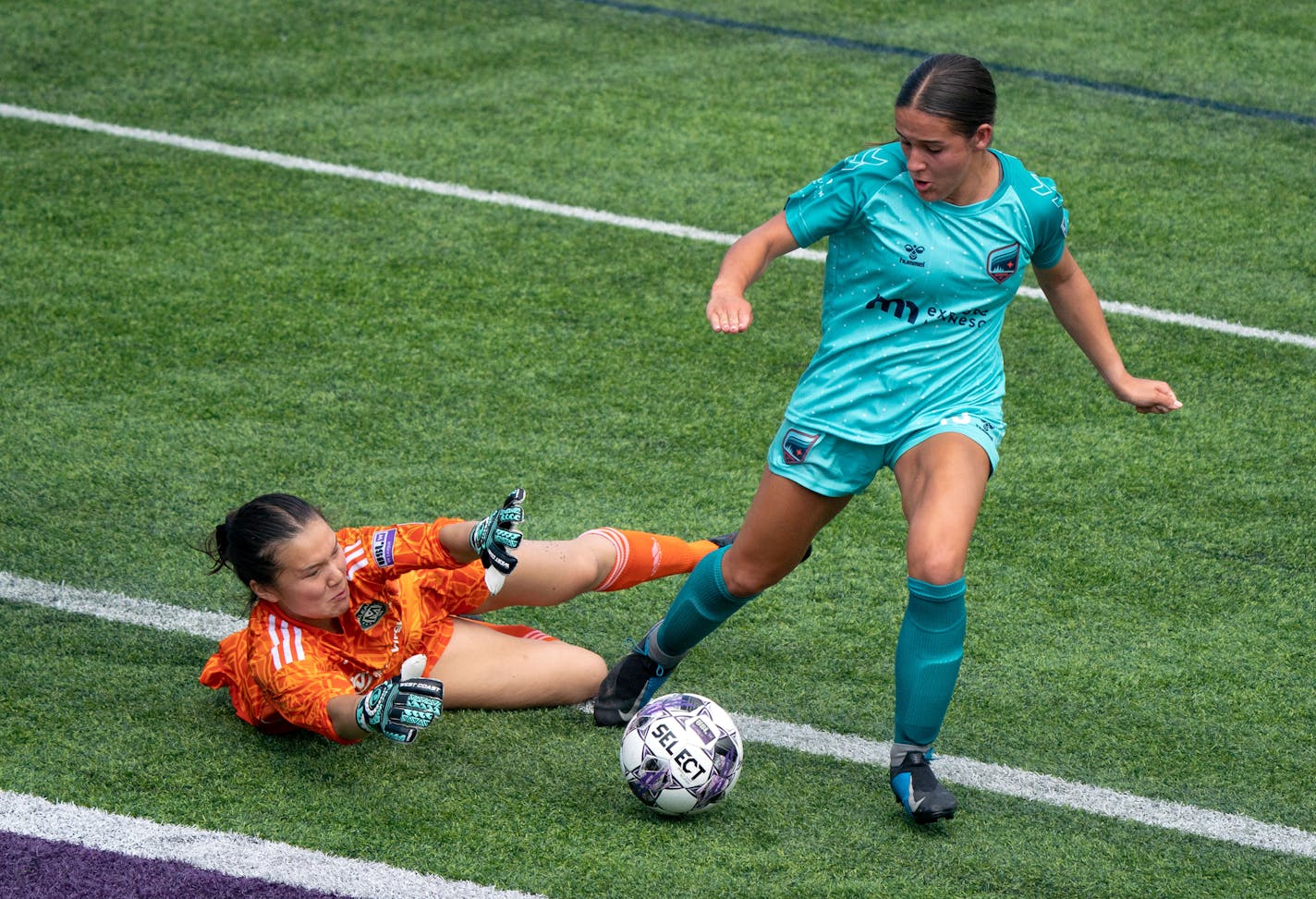 Virginia-based McLean Soccer goalkeeper Ella Gantman (1) tries to intercept a shot from Minnesota Aurora forward Maya Hansen (13) during the first half in the USL W League semifinals Saturday, July 17, 2022 at TCO Stadium in Eagan, Minn. ]