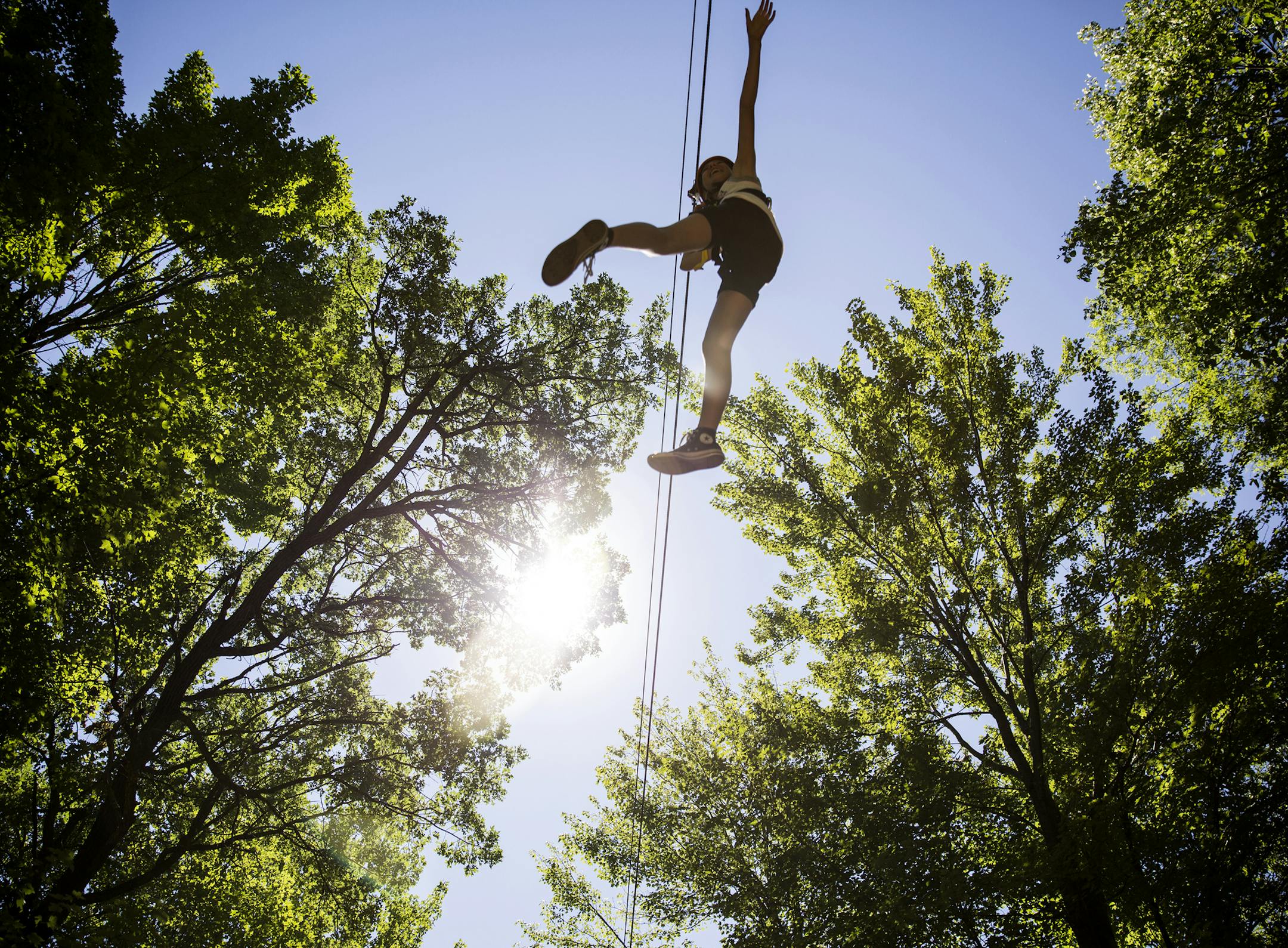 A customer rides one of the six zip lines at Trollhaugen Aerial Adventure Park in Dresser, Wis.