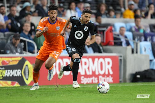 Minnesota United's Emmanuel Reynoso, right, dribbled away from FC Cincinnati's Ian Murphy on Saturday May 7, 2022, at Allianz Field in St. Paul. Cincinnati won 1-0. (courtesy of Minnesota United)