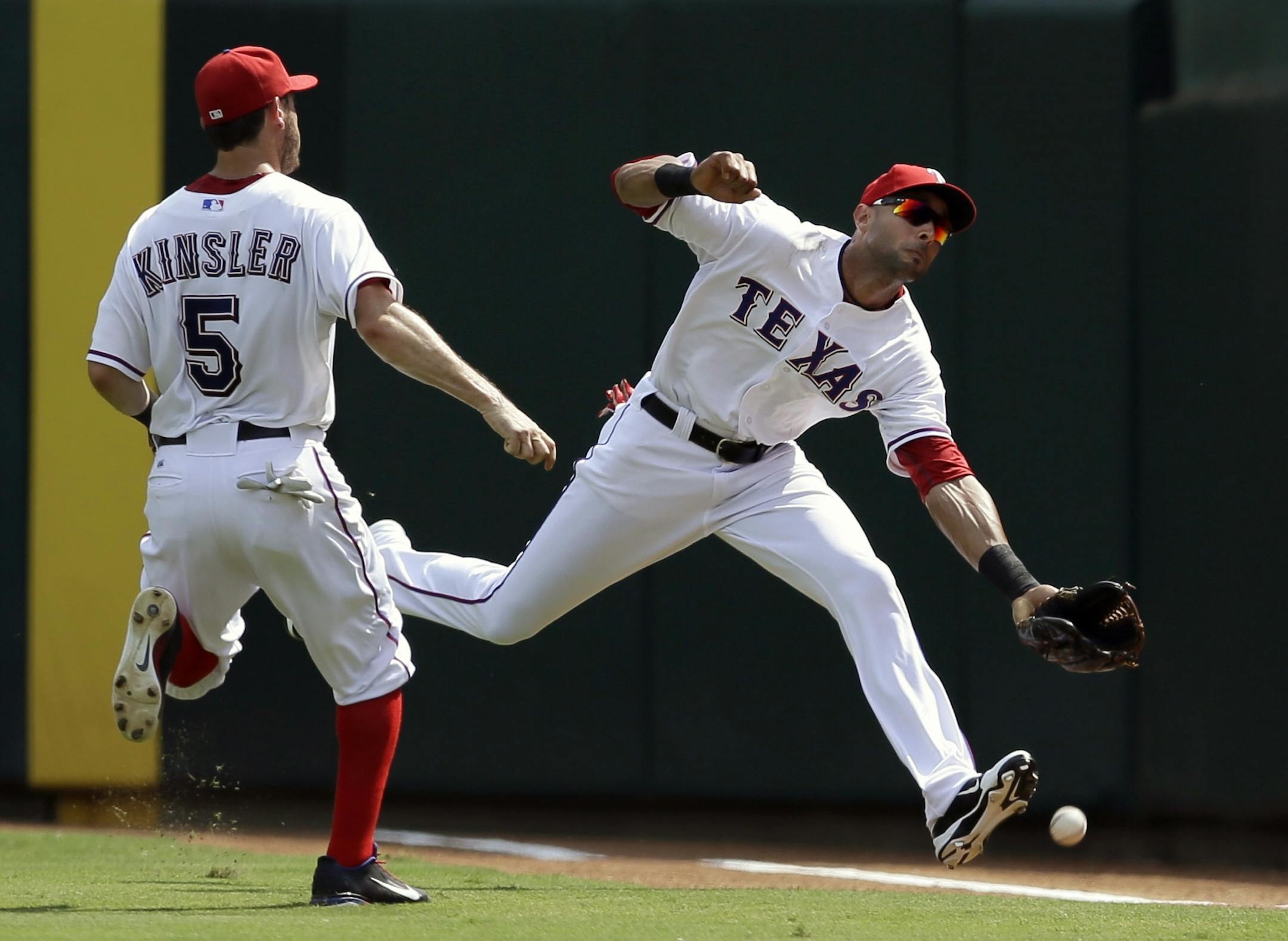Texas Rangers' Ian Kinsler (5) watches as right fielder Alex Rios, right is unable to reach a ground rule double by Minnesota Twins' Doug Bernier in the fifth inning of a baseball game, Sunday, Sept. 1, 2013, in Arlington, Texas.