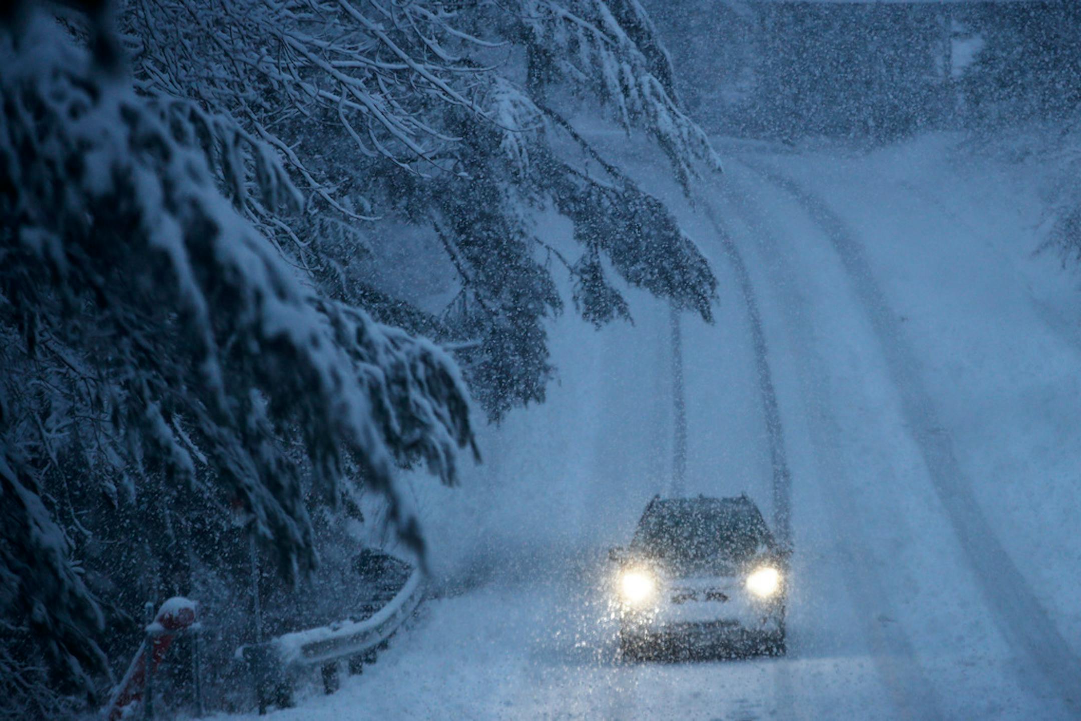 A springtime snowstorm created challenging driving conditions,Thursday, April 9, 2020, in Freeport, Maine.