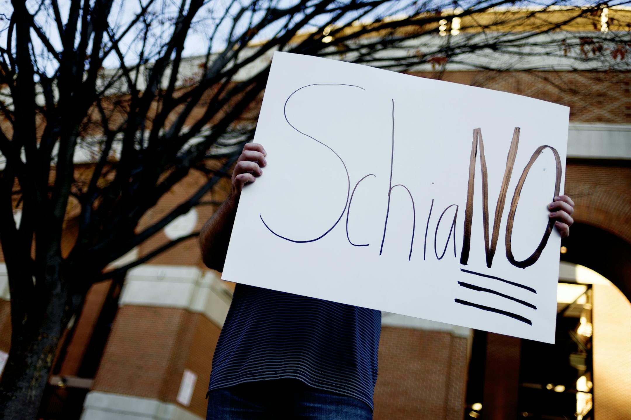 A Tennessee fan holds a sign reading "SchiaNO" during a gathering of Tennessee fans reacting to the possibility of hiring Ohio State defensive coordinator Greg Schiano for its head coaching vacancy Sunday, Nov. 26, 2017, in Knoxville, Tenn. (Calvin Mattheis/Knoxville News Sentinel via AP)