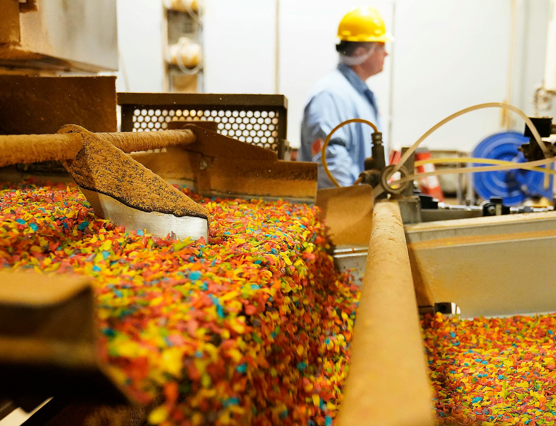 Rice is popped and emerges onto a conveyor to become Fruity Dyno Bites.
