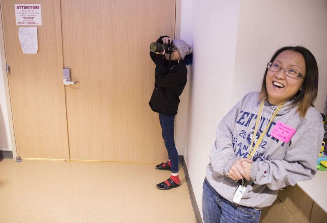 Nat Hawley takes photos inside the scan room after her bone scan as her mother Katy laughs.