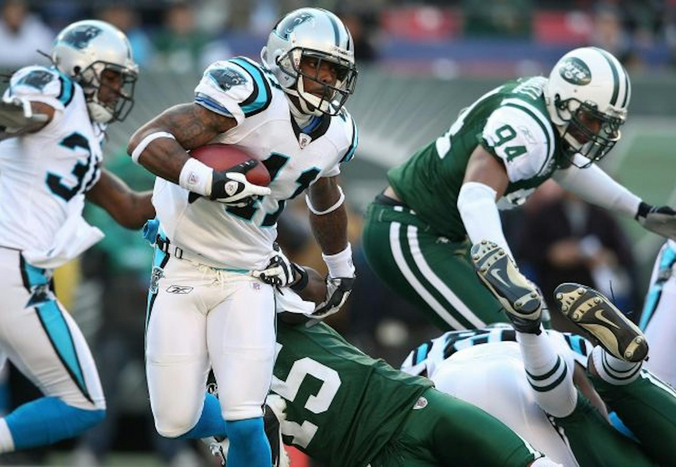 EAST RUTHERFORD, NJ - NOVEMBER 29: Captain Munnerlyn #41 of the Carolina Panthers rushes against the New York Jets at Giants Stadium on November 29, 2009 in East Rutherford, New Jersey.