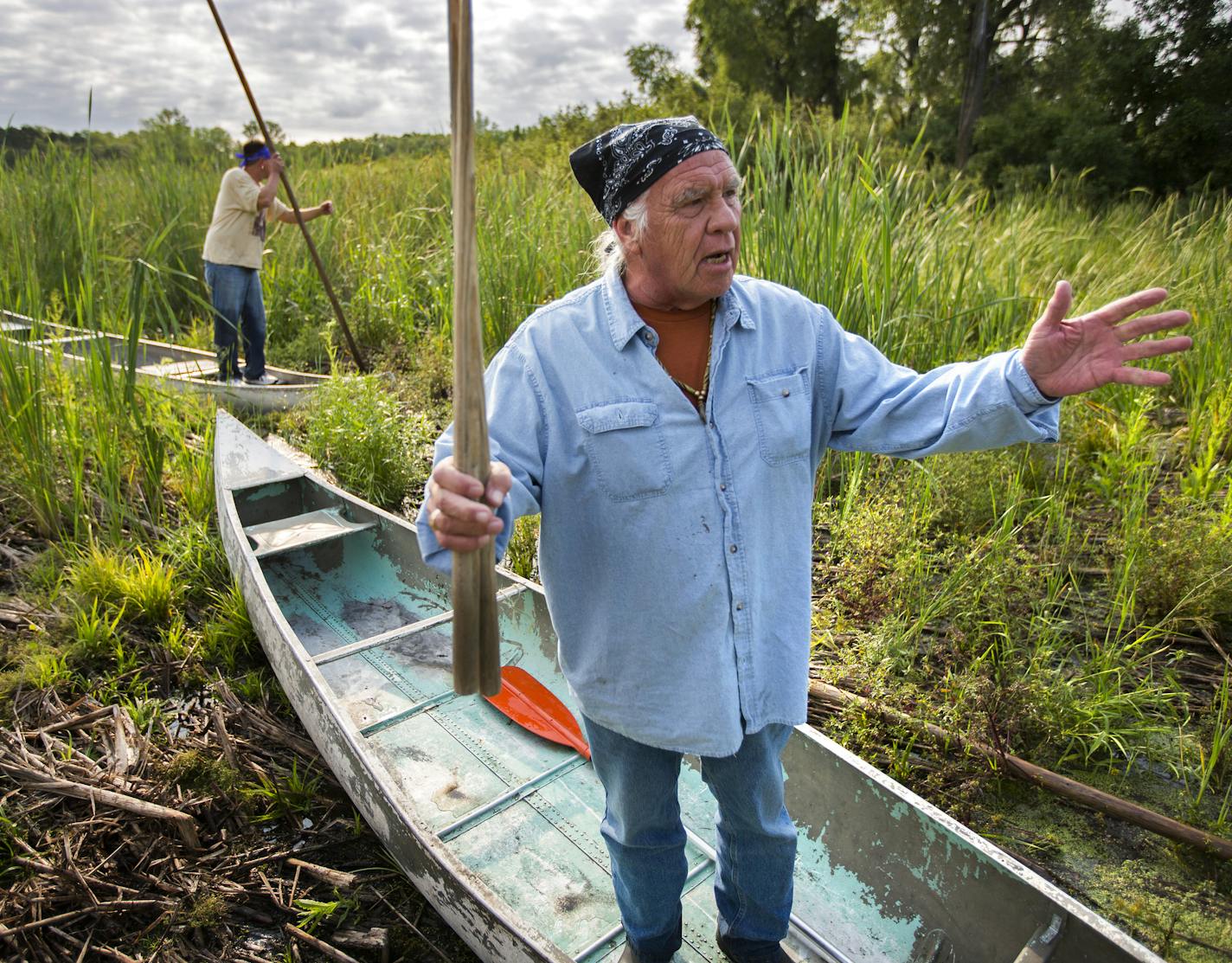 Leonard Thompson (front) and his son Todd spoke to the gathered crowd on Thursday before heading out into Hole-in-the-Day Lake to harvest wild rice.