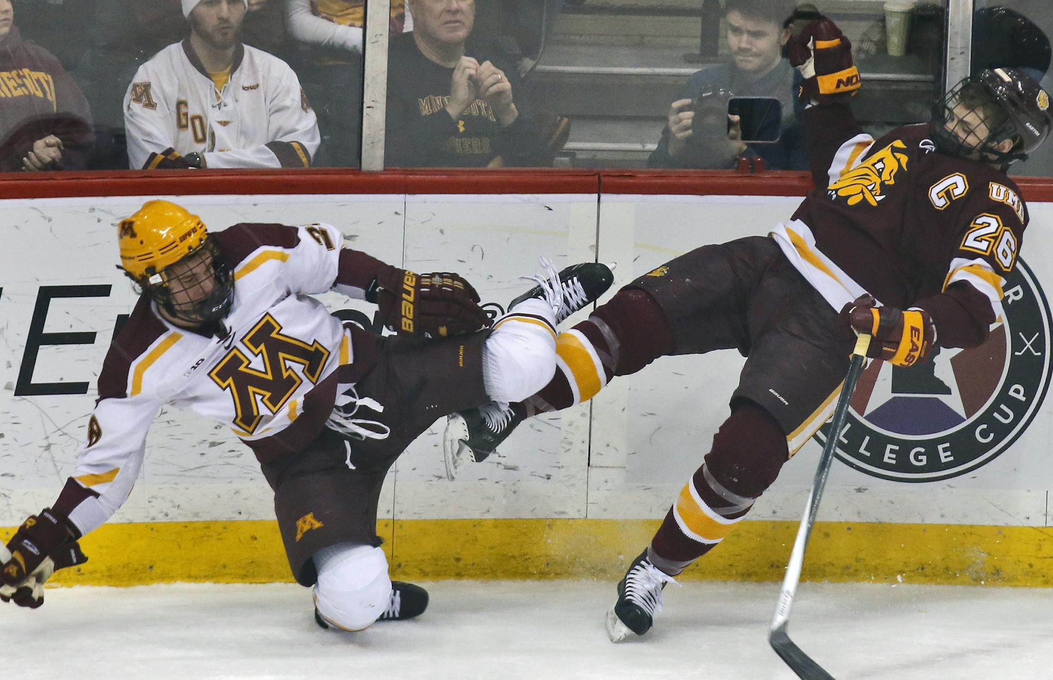 The Gophers' Jake Bischoff, left, and Bulldogs Adam Krause went flying after a check along the boards during a game last season.