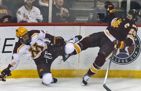 The Gophers' Jake Bischoff, left, and Bulldogs Adam Krause went flying after a check along the boards during a game last season.