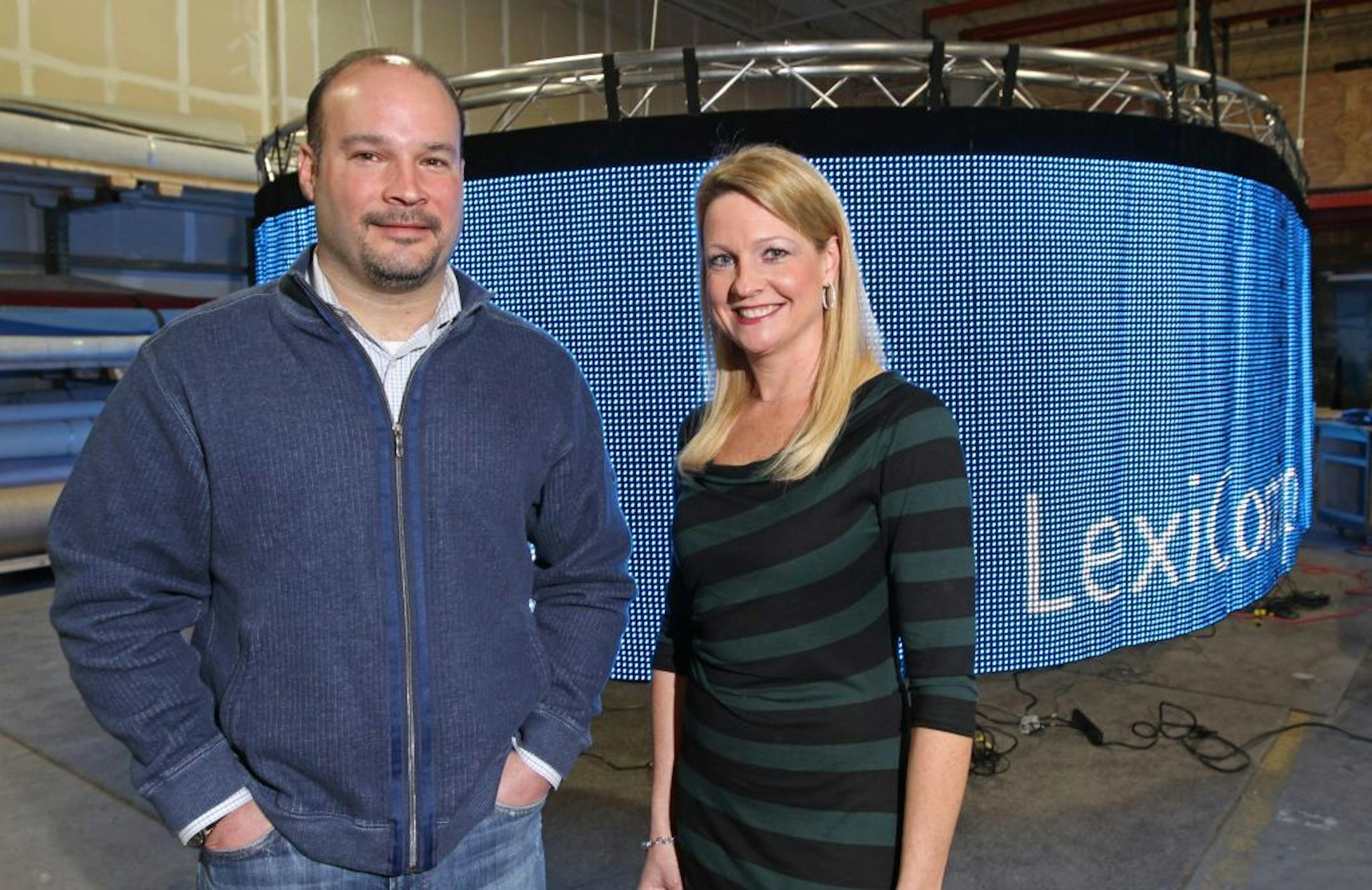 (left to right) nParallel Executive Vice President Don Gonse and President Megan Diamond, photographed on 1/17/13 at the Plymouth MN., company offices, with a LED light curtain for client Wolters Kluwer Health. nParallel makes trade show exhibits for clients. It also makes customized exhibits to rent to clients who cant afford to buy one.