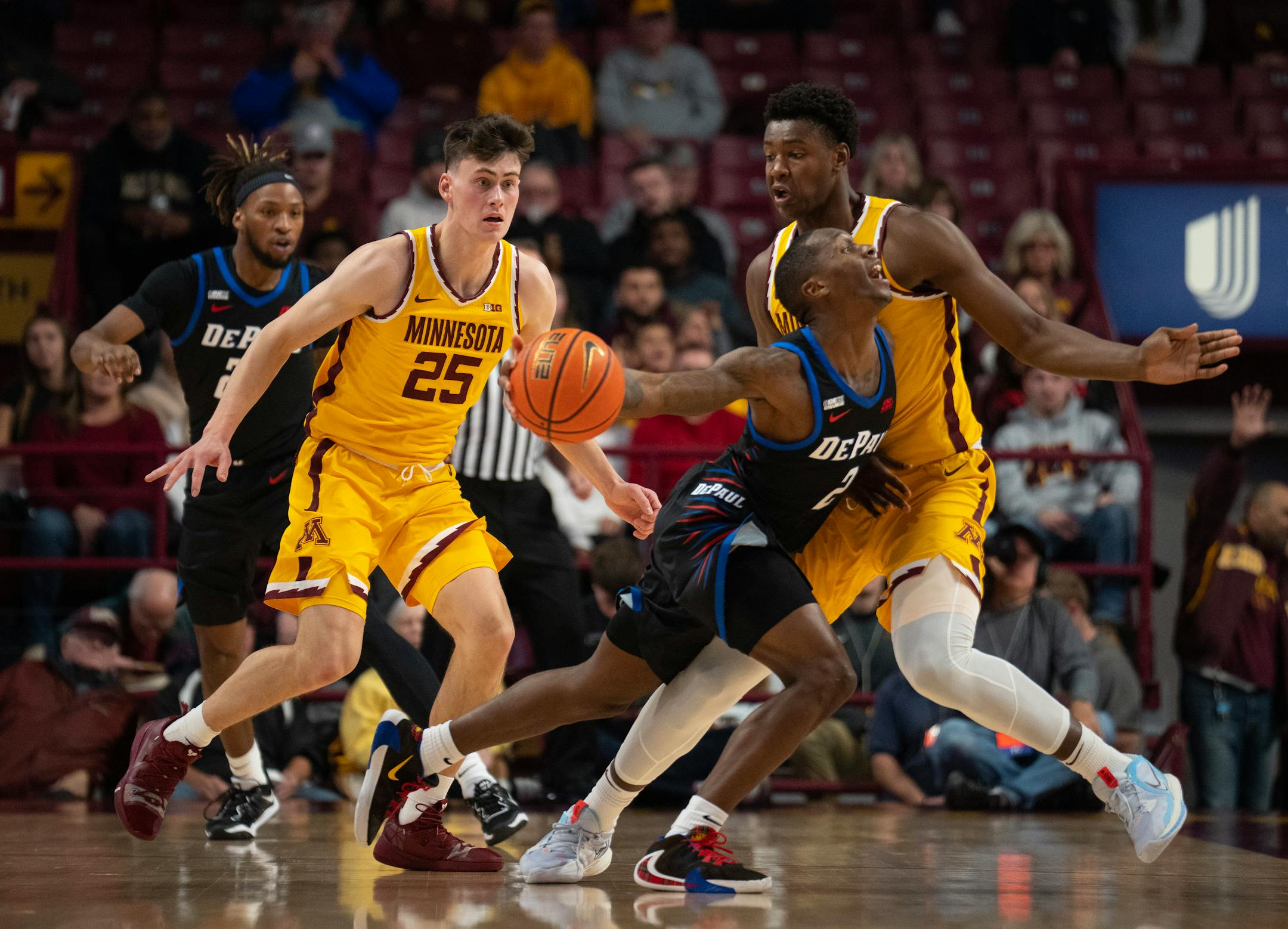 DePaul Blue Demons guard Umoja Gibson (2) was fouled as he drove into Minnesota Gophers forward Pharrel Payne (21) in the first half.