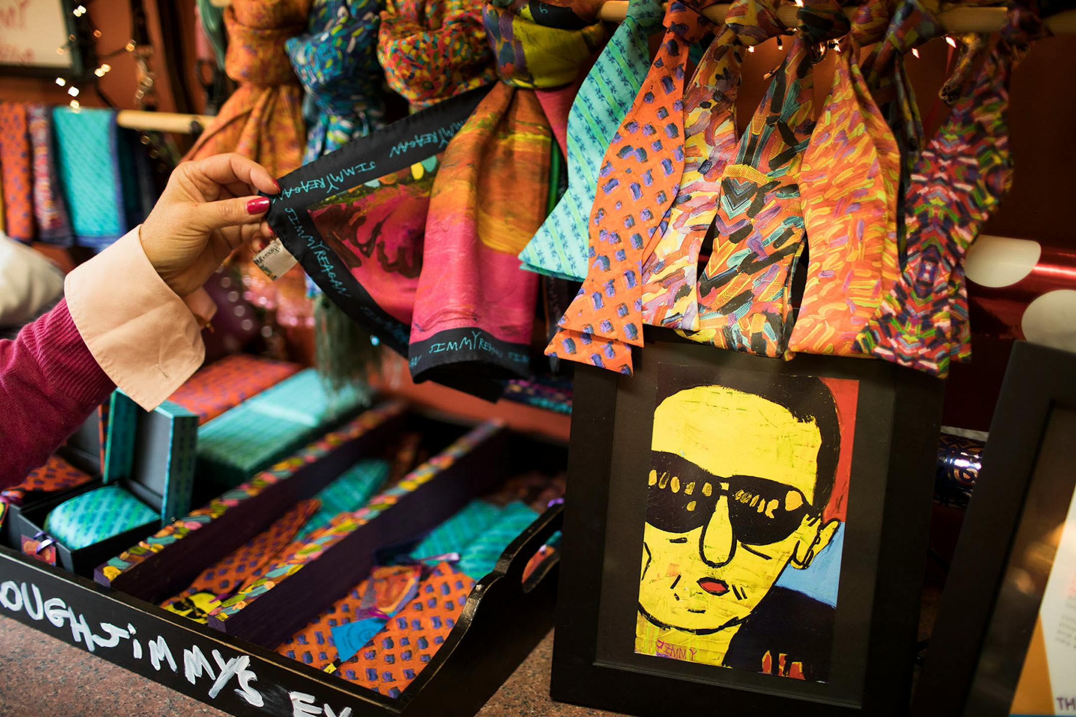 Scarves and bowties that were made from Jimmy Reagan's paintings.