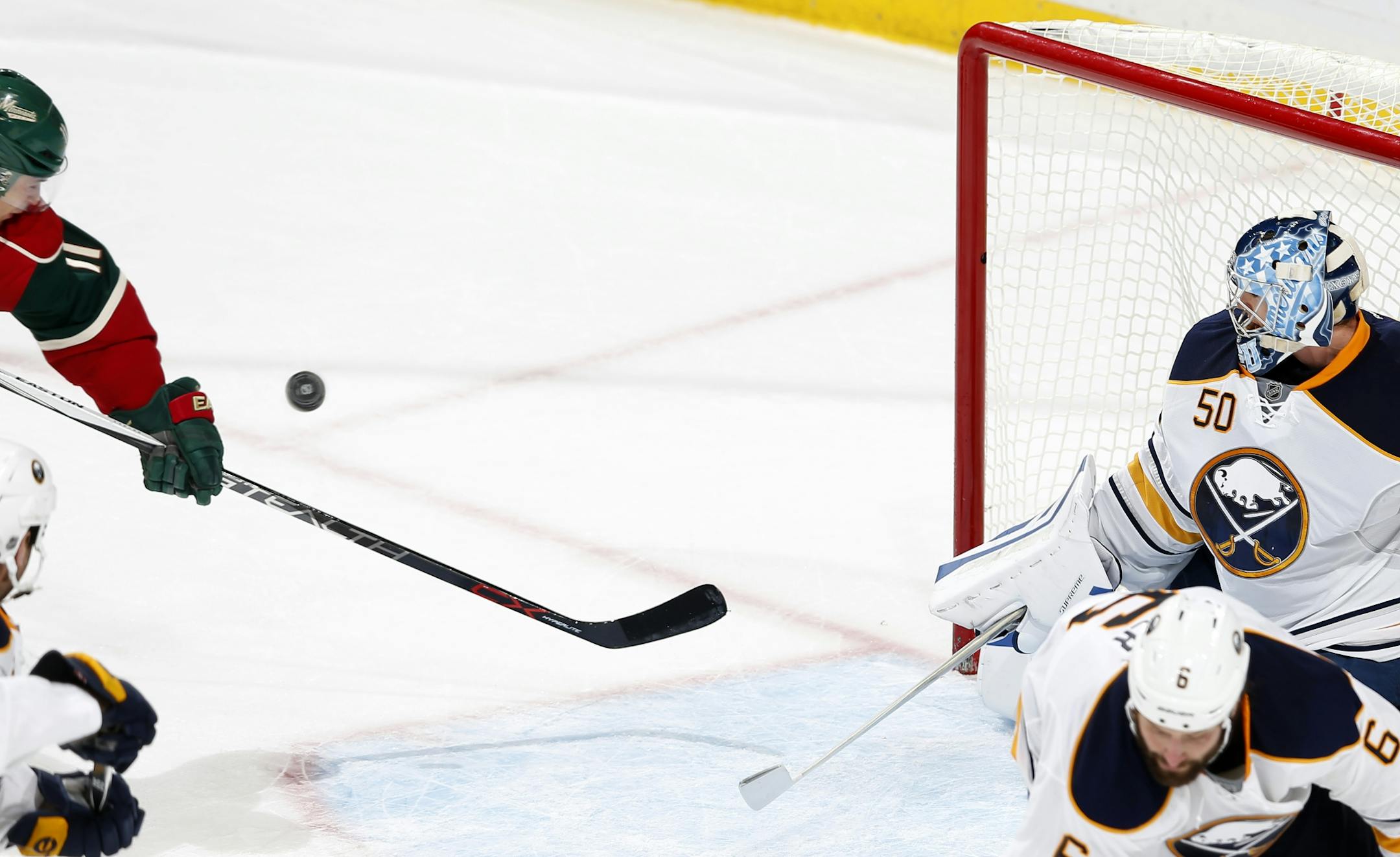 Zach Parise (11) got the puck past Sabres goalie Nathan Lieuwen (50) during the exhibition overtime.