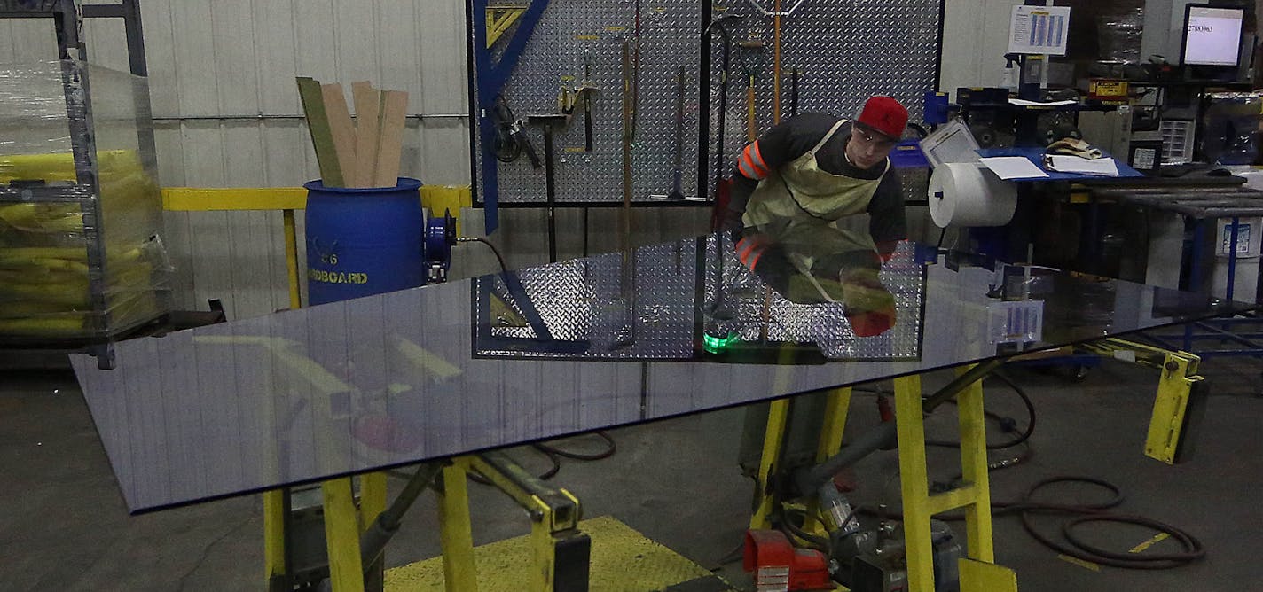 Viracon worker Matt Smith prepared a panel of glass for shipping the installer for construction of the new Vikings Stadium. ] JIM GEHRZ &#xef; james.gehrz@startribune.com / Owatonna, MN / February 12, 2015 /11:00 AM - BACKGROUND INFORMATION: Glass maker Viracon begins producing the windows for the new Vikings Stadium in February. We have been invited in for a tour. The company CEO will see some of the first windows roll off the production line. The plant is in Owatonna.