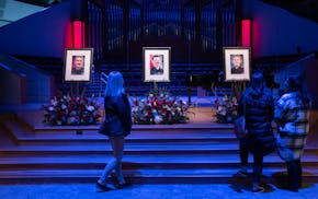 Mourners pay their respects after a livestream at a church in Burnsville of the memorial service Wednesday.