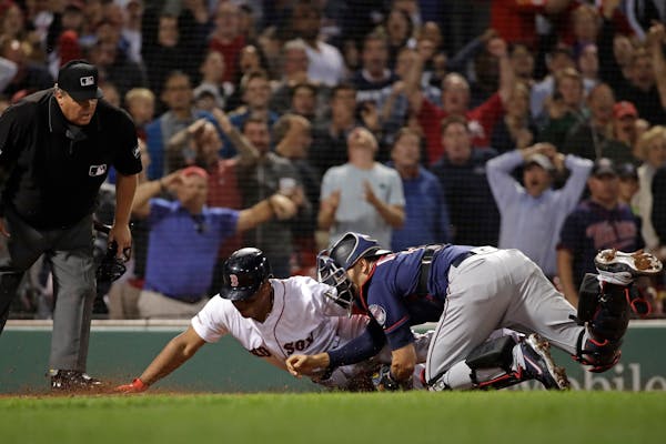 He's out! Jason Castro tagged the Red Sox's Rafael Devers at home in the ninth inning, preserving the Twins' 2-1 victory and a series win at Fenway Pa