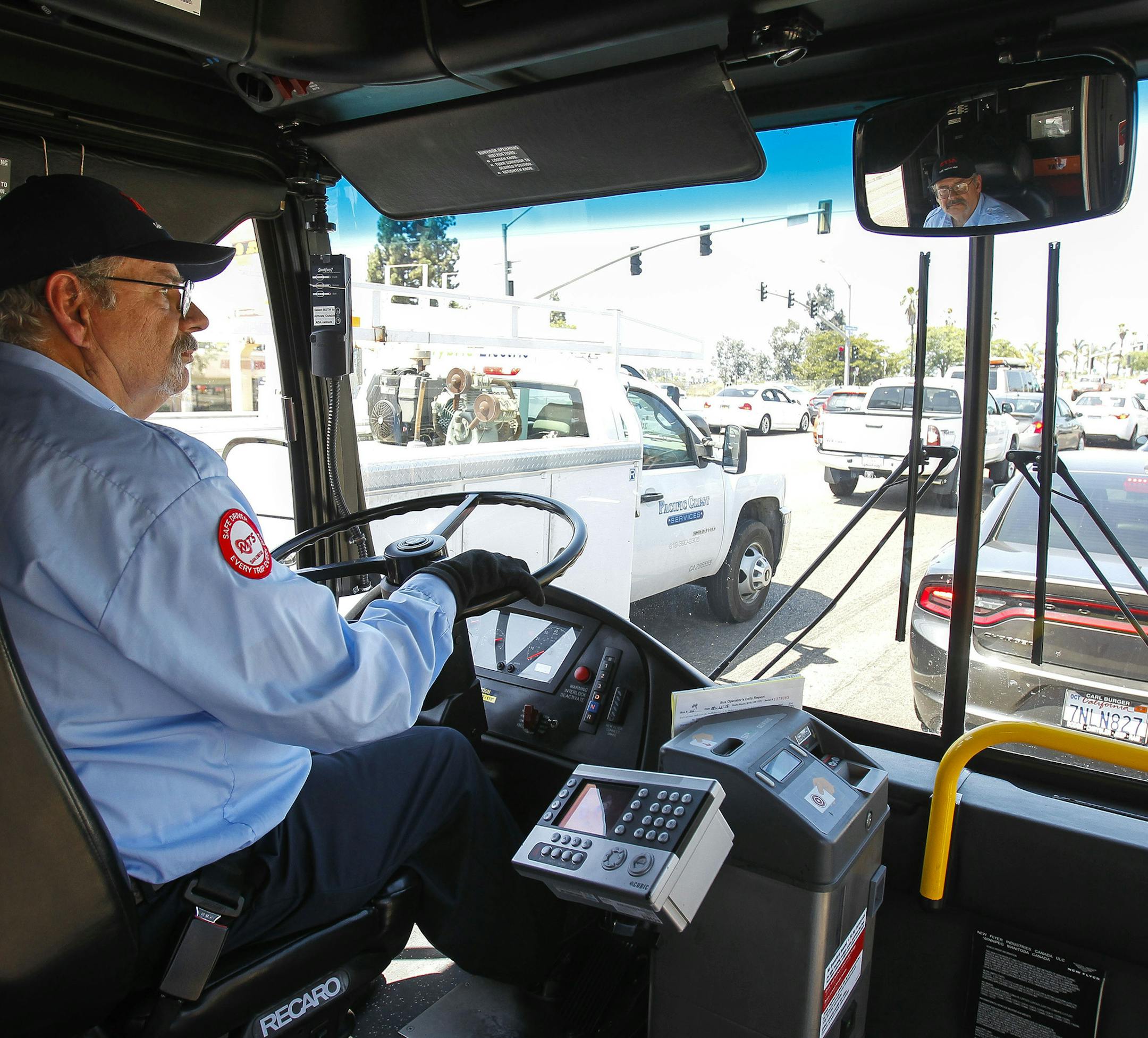 MTS bus driver Tom Middleton, 66, who had a career as a software engineer, waits at traffic light on Clairemont Mesa Boulevard in San Diego while driving his route to Escondido on Aug. 22, 2018. (Hayne Palmour IV/San Diego Union-Tribune/TNS) ORG XMIT: 1239590
