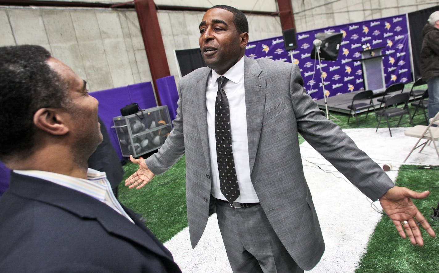 Former Vikings player Cris Carter, who was recently voted into the Football Hall of Fame, at Winter Park with former teammate Leo Lewis.