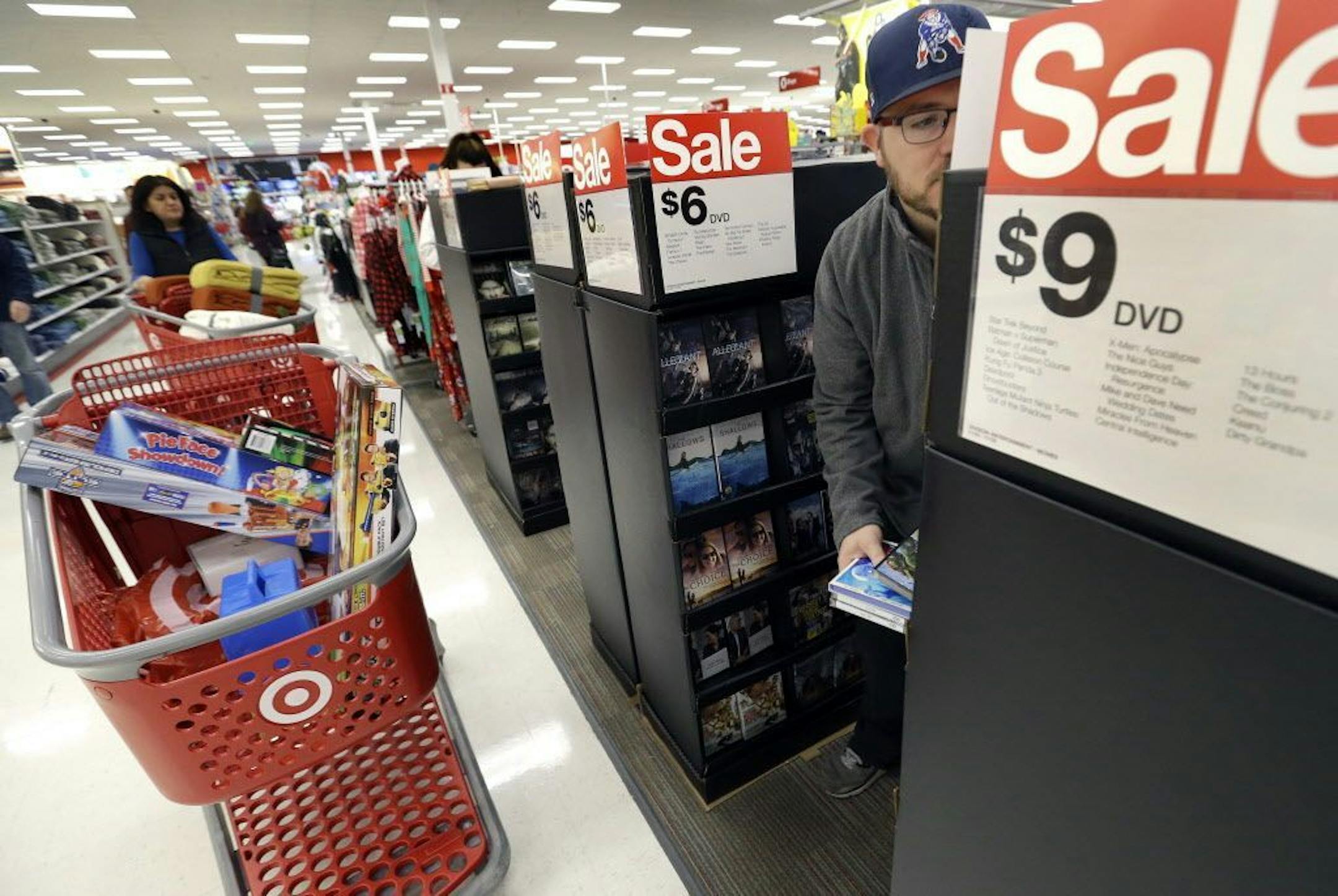FILE - In this Friday, Nov. 25, 2016, file photo, Paul Poirier shops for sales at a Target store, in Wilmington, Mass.