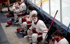 Benilde-St. Margaret’s players rested in a makeshift locker room area with social distancing in the arena last January.