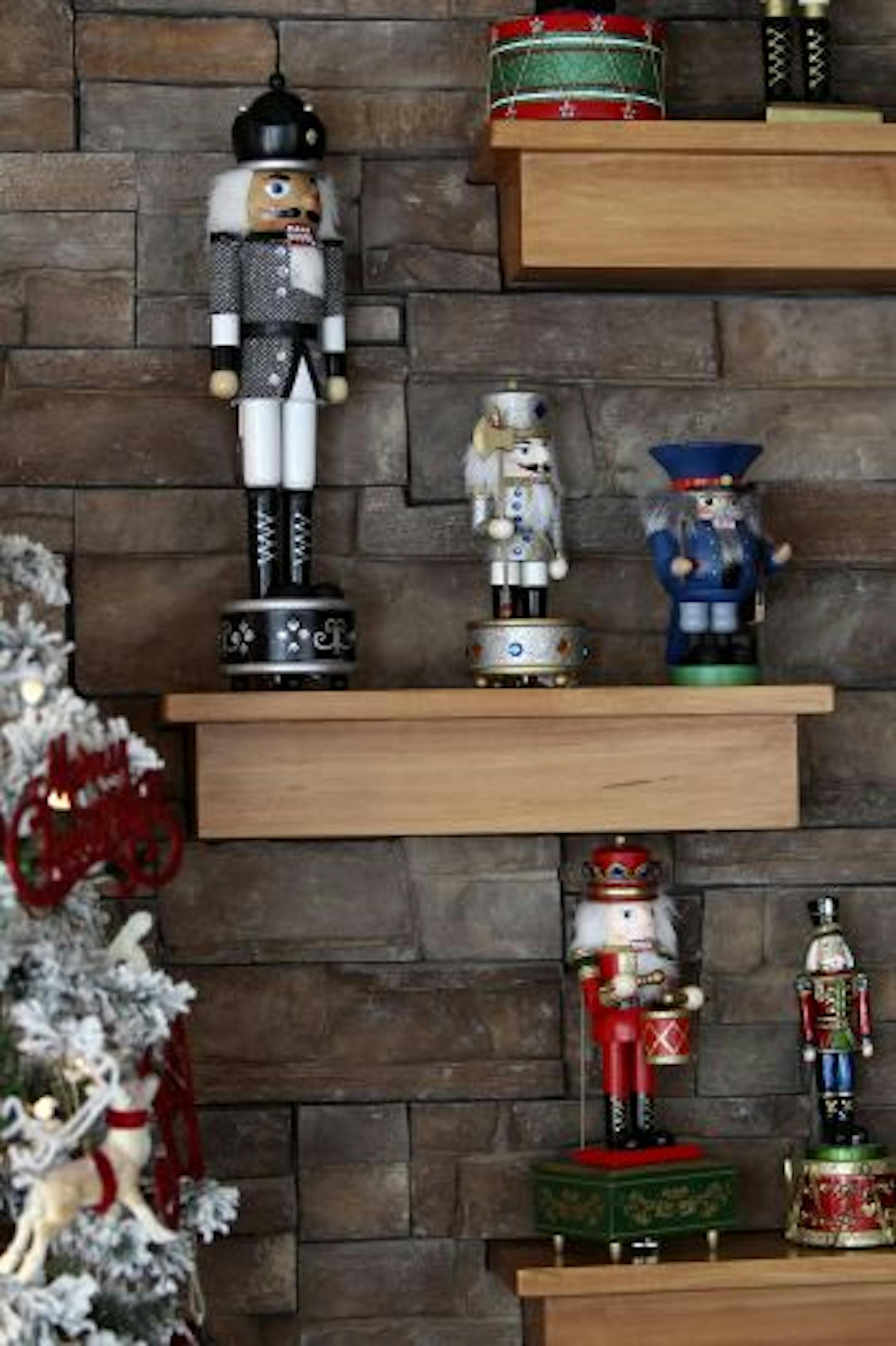 Sheryl Amos worked on decorating dining room light in a home that has taken three days to decorate.