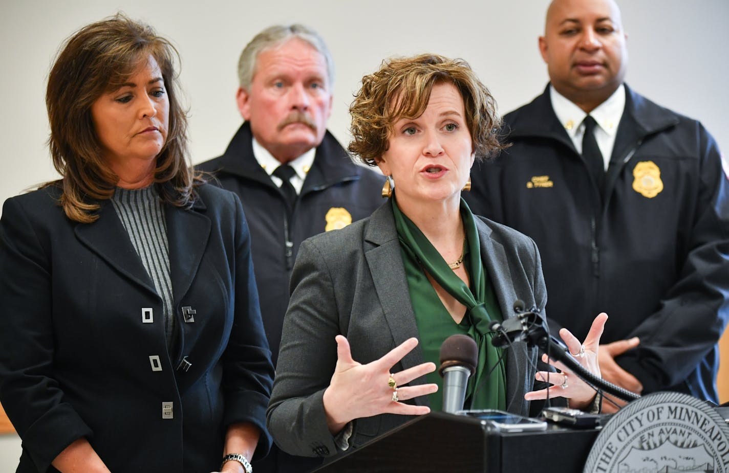 Mayor Betsy Hodges and Police Chief Janee Harteau held a press conference to react to the DOJ report. Behind them Minneapolis Fire Chief John Fruetel and Minneapolis Battalion Chief Bryan Tyner.