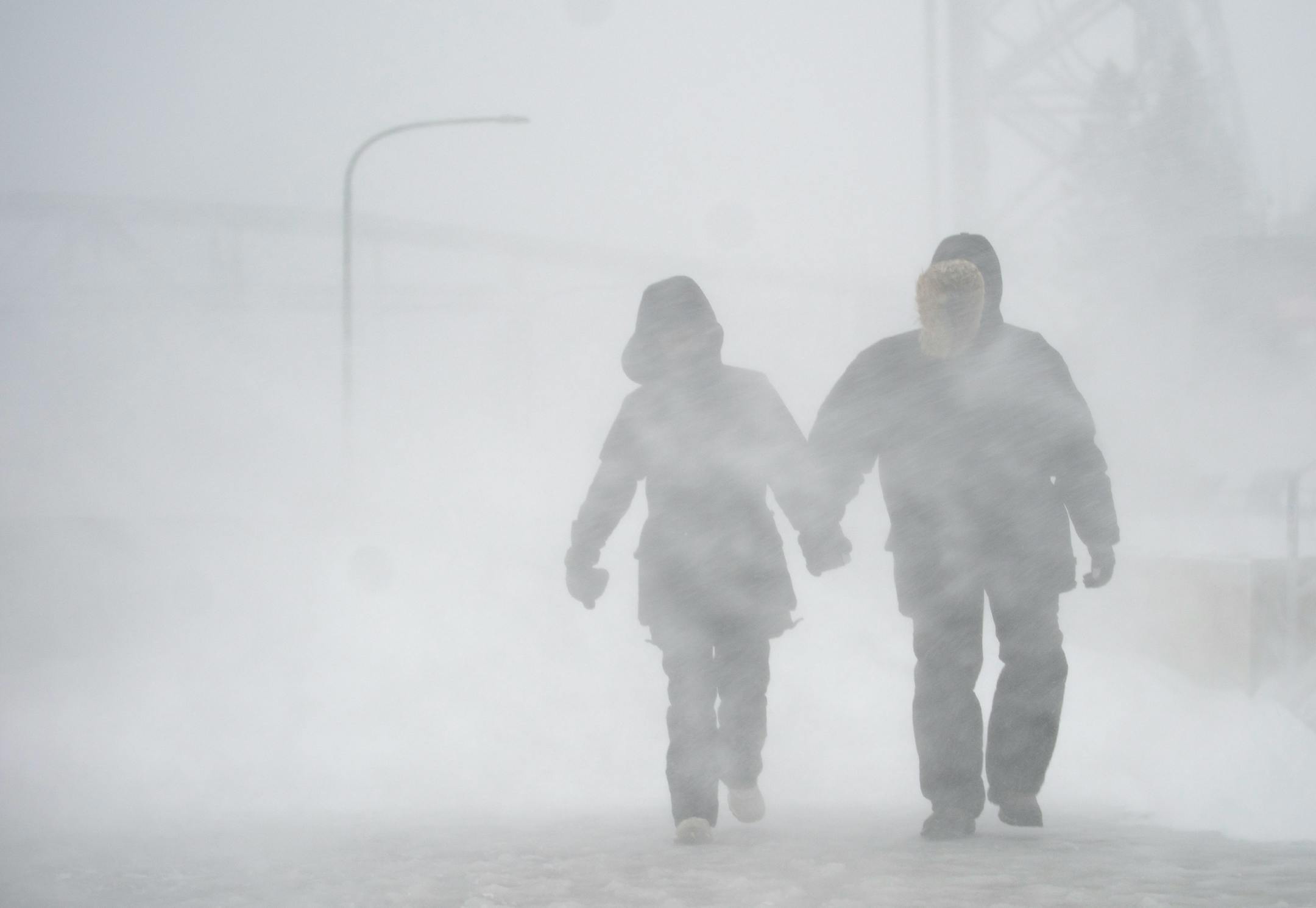 Angel Fuchs and Marc Veillet enjoyed a walk in Canal Park in Duluth on Wednesday afternoon as the snow and wind picked up.